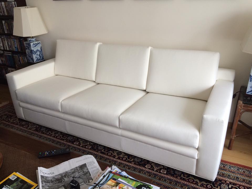 White sofa with neatly tailored cushions in a home